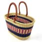 Angled view of the extra large oval Bolga basket with navy bands framing a pink and cream striped band, showing the woven interior