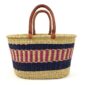 Front view of the extra large oval Bolga basket with navy bands framing a pink and cream striped band on a white background