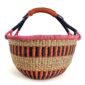 Front view of the orange and pink XL round Bolga basket with a leather-wrapped handle on a white background