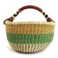 Front view of the orange and green XL round Bolga basket with a leather-wrapped handle on a white background