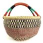 Front view of the red and green XL round Bolga basket with a leather-wrapped handle on a white background