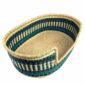 Angled view of the large teal and navy pet basket showing the woven elephant grass base