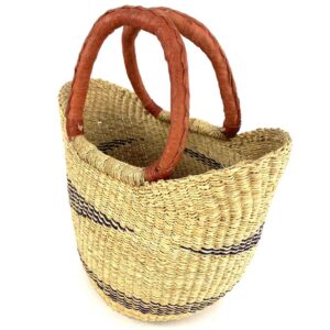 Diagonal angle of a mini market basket, showing its round base and upward-sloping sides, emphasizing the handwoven craftsmanship and bold design