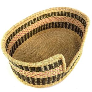 Angled view of the medium Bolga dog bed showing the charcoal and pink bands inside