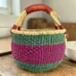 Medium round Bolga basket with green, navy and pink zigzag pattern, leather handles