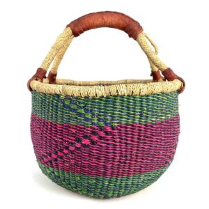 medium-round-basket-665-coastal-woven-2 Angled view of the medium round Bolga basket showing green, navy and pink zigzag pattern