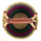 Front view of the medium round Bolga basket with green, navy and pink zigzag pattern