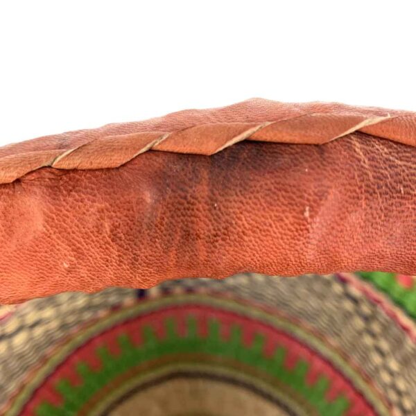 medium-round-basket-666-paradise-woven-4 Close-up of the stained leather handle on the medium round Bolga basket, showing the imperfection