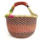 Angled view of the medium round Bolga basket showing a navy, orange, magenta and green checkerboard weave