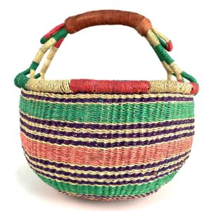 medium-round-basket-680-heron-woven-2 Angled view of the medium round Bolga basket showing a natural-and-red rim with green, purple and coral horizontal stripes