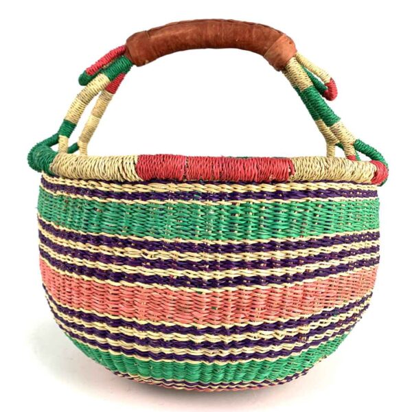 medium-round-basket-680-heron-woven-2 Angled view of the medium round Bolga basket showing a natural-and-red rim with green, purple and coral horizontal stripes