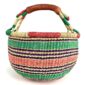 Angled view of the medium round Bolga basket showing a natural-and-red rim with green, purple and coral horizontal stripes