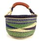 Angled view of the medium round Bolga basket showing a dark purple rim with a green, navy and cream diagonal wave pattern