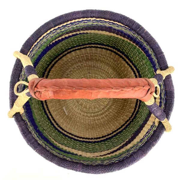 medium-round-basket-683-sunbird-woven-3 Front view of the medium round Bolga basket with a dark purple rim with a green, navy and cream diagonal wave pattern