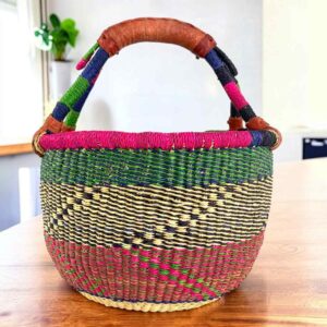 Rich-toned zigzag medium round Bolga basket with leather-wrapped handle, on a timber table