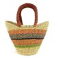 Front view of the mini market basket with warm, earthy stripes on a natural weave