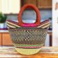 Mini market basket with a dark geometric pattern with a bright rim accent and leather-wrapped handles