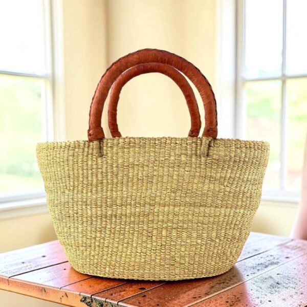 natural-brighton-shopping-basket-bashiri a woven shopping basket in natural colour with tan leather handles