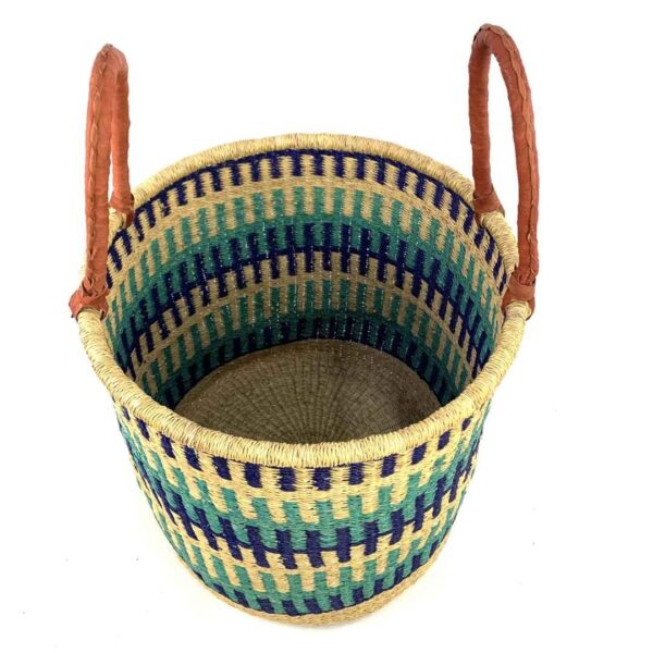 open-laundry-basket-115-wishywashy-blue-green-african-bashiri-2 Angled view of the open laundry basket with navy, teal and green bands on natural straw and tall leather handles