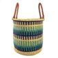 Front view of the open laundry basket with navy, teal and green bands on natural straw and tall leather handles on a white background