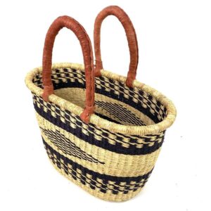 Angled view of the oval Bolga basket with black bands and a central black diamond motif, showing the woven interior