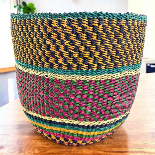 planter-basket-087-castings-jewel-tone-checked-vegan-woven-bolga-bashiri-main Vegan planter basket with jewel-tone checked bands, on a timber table
