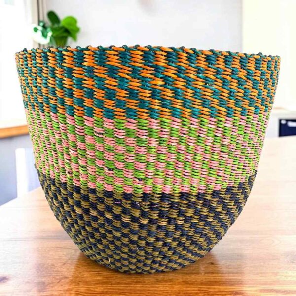 planter-basket-088-mulch-earthy-colour-block-vegan-african-basket-bashiri-main Vegan planter basket woven in three tiers of checked, muted and deep tones, on a timber table