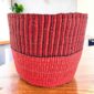Vegan planter basket in two warm shades, ribbed above a smooth base, on a timber table