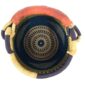 Top view inside the Bolga pot basket with orange, navy and green bands above a black and natural diagonal pattern and a leather-wrapped handle