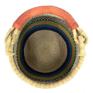 Top view inside the Bolga pot basket with green, orange and teal bands with a black and natural check and a leather-wrapped handle