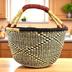 Front view of a large round Bolga bag with sturdy leather handles, handwoven from elephant grass in Ghana