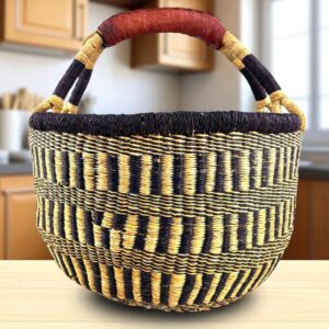 Front view of a large round Bolga bag with sturdy leather handles, handwoven from elephant grass in Ghana