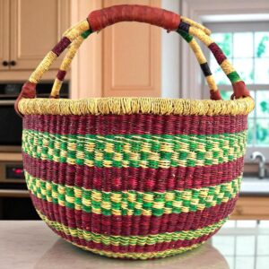 Front view of a large round Bolga bag with sturdy leather handles, handwoven from elephant grass in Ghana
