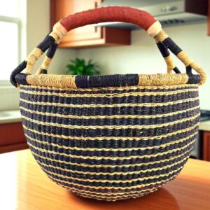 Front view of a large round Bolga bag with sturdy leather handles, handwoven from elephant grass in Ghana