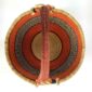 Top-down view inside the orange and black xl round bolga basket, showing the coiled base