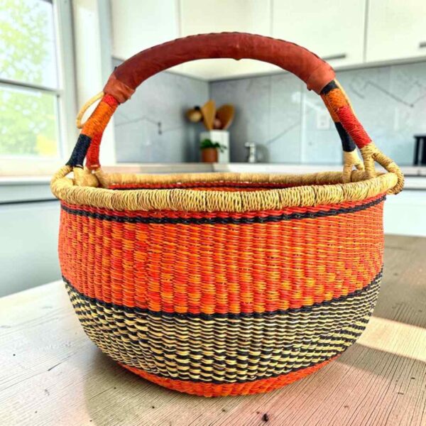 round-basket-xl-563-collosus-orange-black-bolga-woven-bashiri-main XL round Bolga basket in orange and black, handwoven from elephant grass
