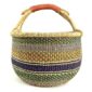 Front view of the green and mustard xl round bolga basket on a white background
