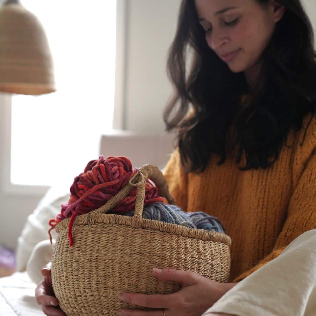 Round natural Bolga basket held by a woman in a warm knit sweater, filled with colourful yarn balls

A few notes on the approach: the alt text leads with the product, includes a lifestyle detail that supports the image content, and stays descriptive without keyword stuffing. "Ghana" in the file name adds geographic specificity that can help with niche search queries around Bolga/Ghanaian baskets, consistent with how Bashiri positions the range.



