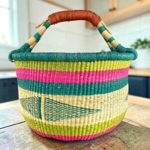 Large round Bolga basket with a summery, beach-toned weave, leather handles