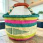 Large round Bolga basket with a summery, beach-toned weave, leather handles