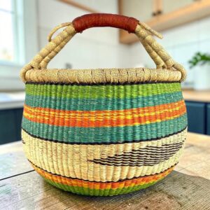 Large round Bolga basket with a diamond motif through the weave, leather handles