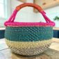 Large round Bolga basket with a bright contrasting rim, leather handles