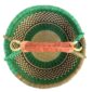 Top-down view inside the large round Bolga basket with a fresh leafy band over a warm earthy checkerboard, showing the coiled base and leather handle