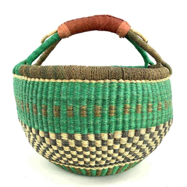 round-large-basket-856-radiance-green-brown-bolga-african-bashiri-3 Front view of the large round Bolga basket with a fresh leafy band over a warm earthy checkerboard, on a white background