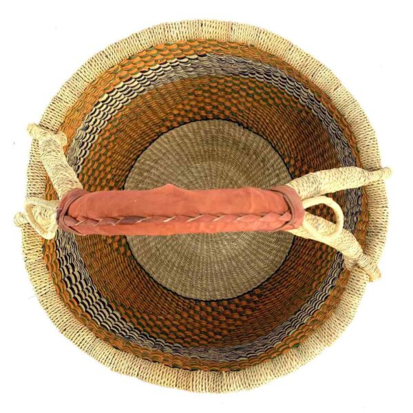 round-large-basket-857-bliss-orange-black-woven-bolga-bashiri-2 Top-down view inside the large round Bolga basket with warm amber tones and a dark diagonal checkerboard, showing the coiled base and leather handle
