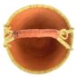 Top-down view inside the large round Bolga basket with a single warm terracotta tone and natural rim, showing the coiled base and leather handle
