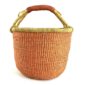 Front view of the large round Bolga basket with a single warm terracotta tone and natural rim, on a white background