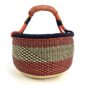 Front view of the large round Bolga basket with deep red and inky diagonal sections, on a white background