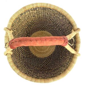 Top-down view inside the large round Bolga basket with natural straw and deep inky fine checks, showing the coiled base and leather handle