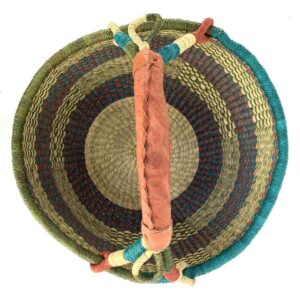 Top-down view inside the large round Bolga basket with muted olive and slate tones with natural checks, showing the coiled base and leather handle